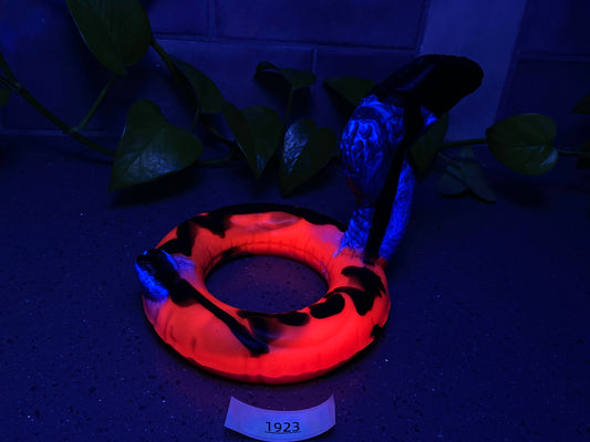 a blue and orange ring sitting on top of a table