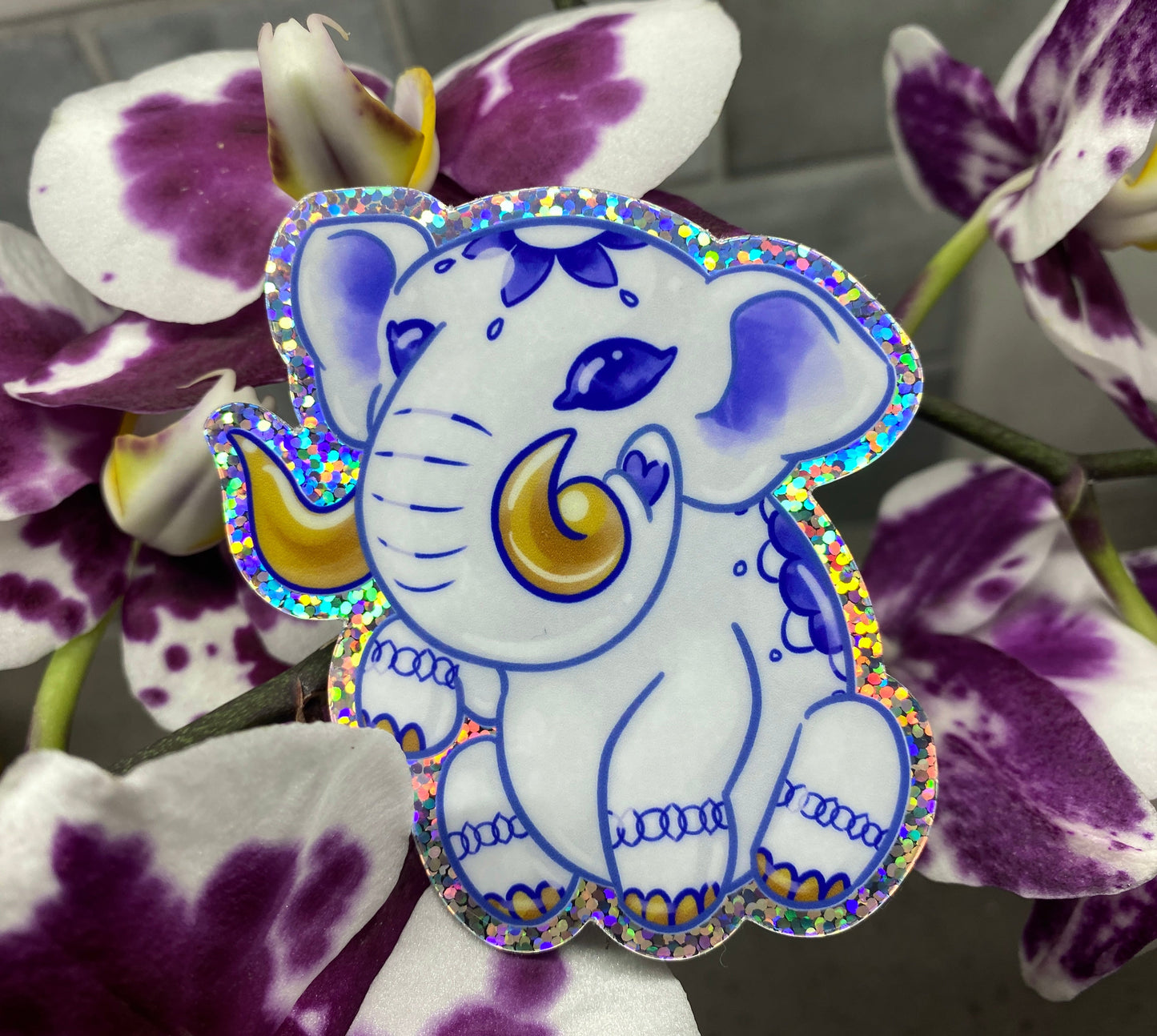 a purple and white flower with a blue and yellow elephant on it