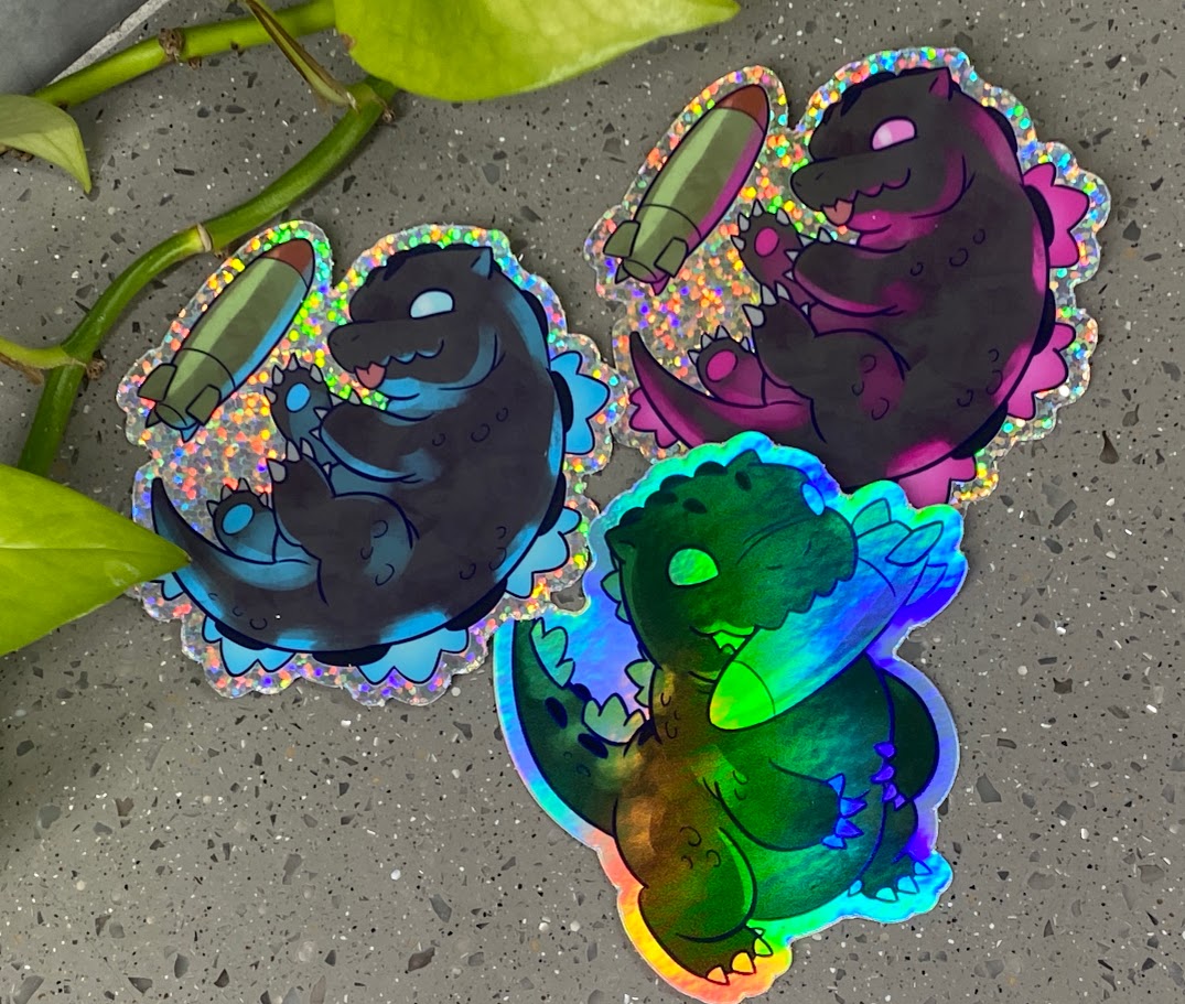 a couple of stickers sitting on top of a cement ground