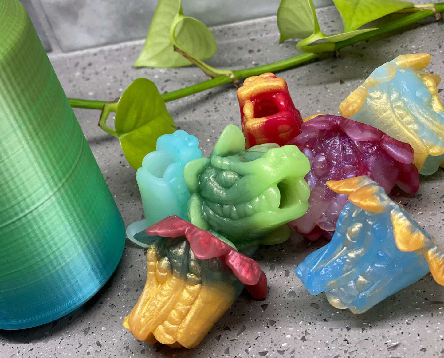 a group of plastic toys sitting next to a spool of thread