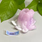 a pink flower sitting on top of a white table