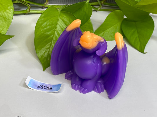 a purple figurine sitting on top of a table