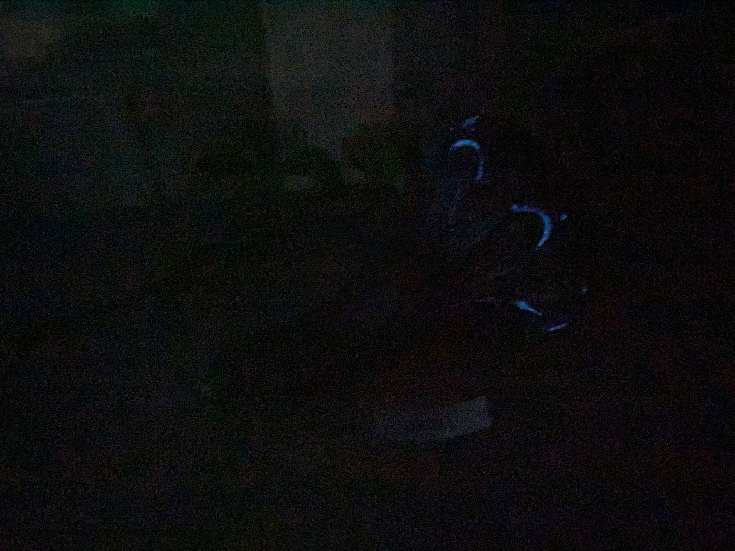 a person sitting in a chair in the dark