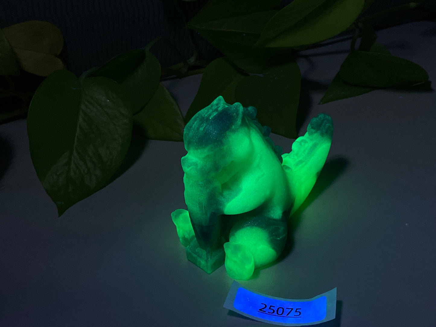 a glowing green teddy bear sitting on top of a table