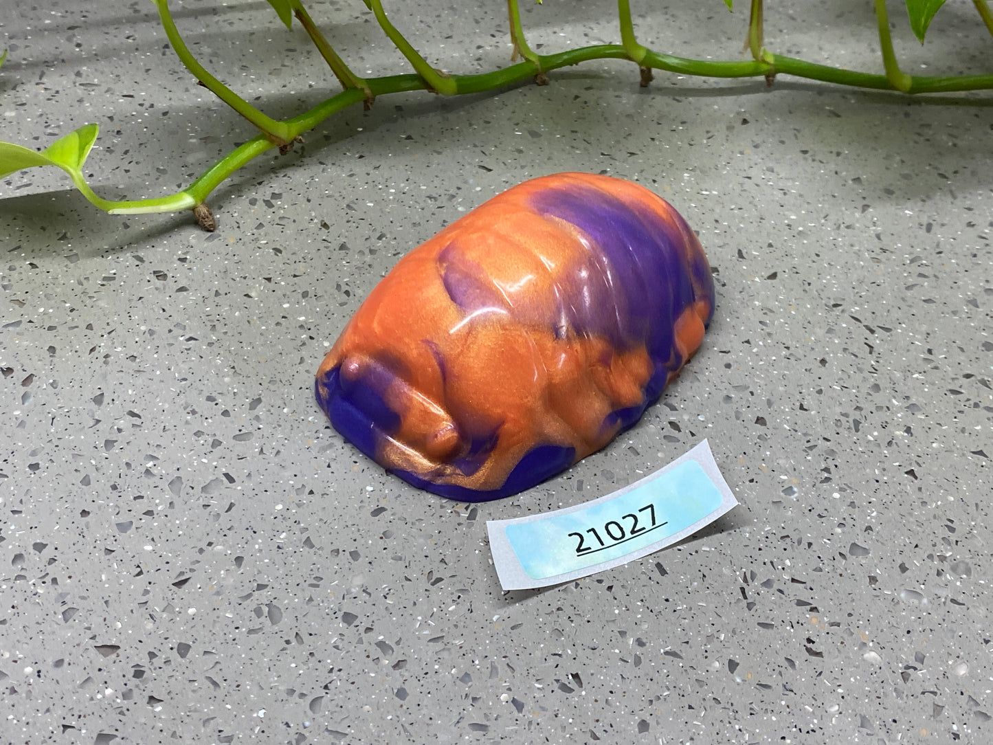 a purple and orange vase sitting on top of a table