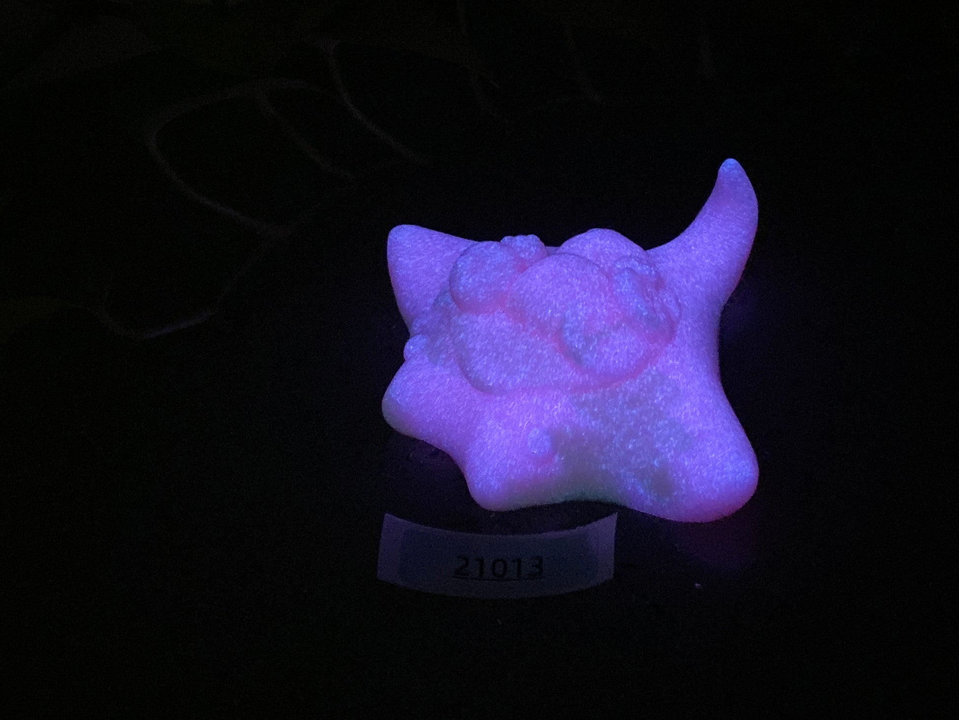 a glow in the dark object with a black background