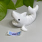 a white dolphin figurine sitting on top of a table