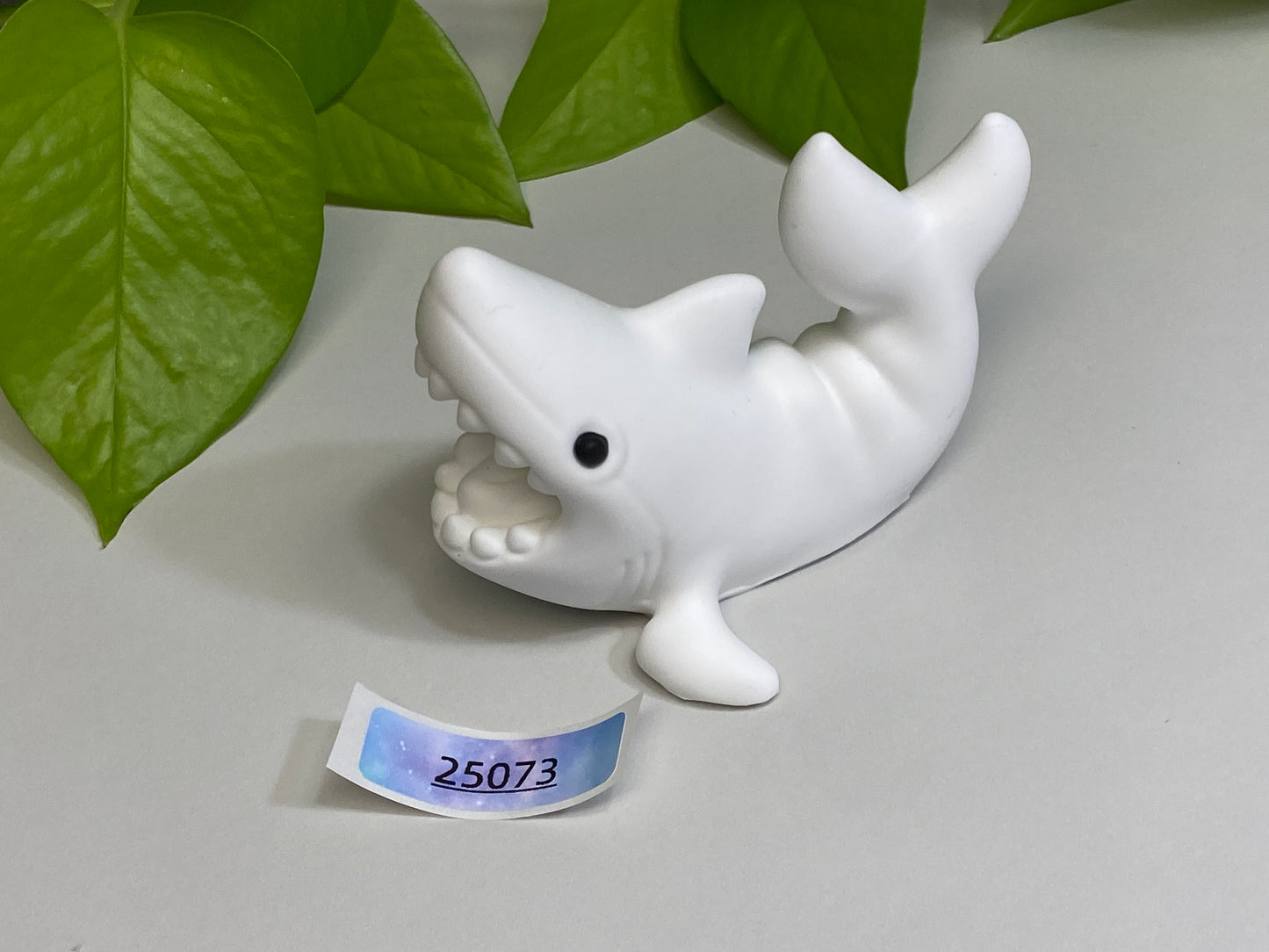 a white dolphin figurine sitting on top of a table