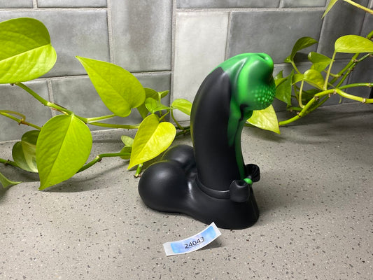 a green and black object sitting on top of a counter