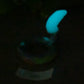 a glowing object in the dark with a blurry background