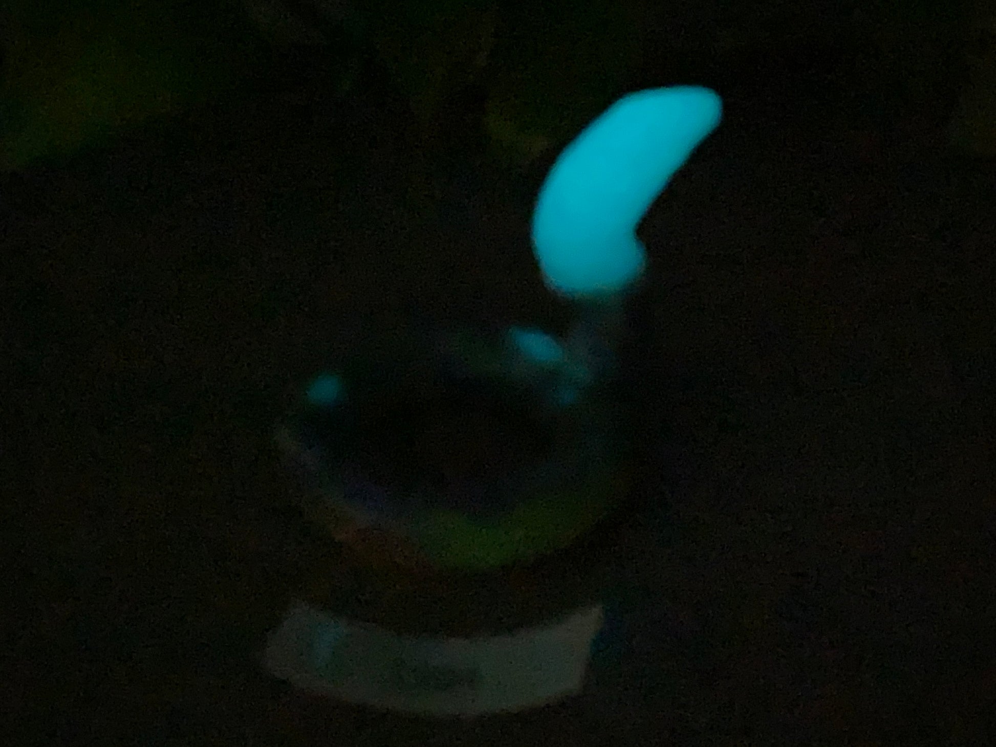 a glowing object in the dark with a blurry background