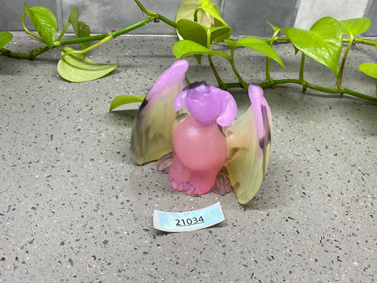 a small figurine of a bird with a name tag