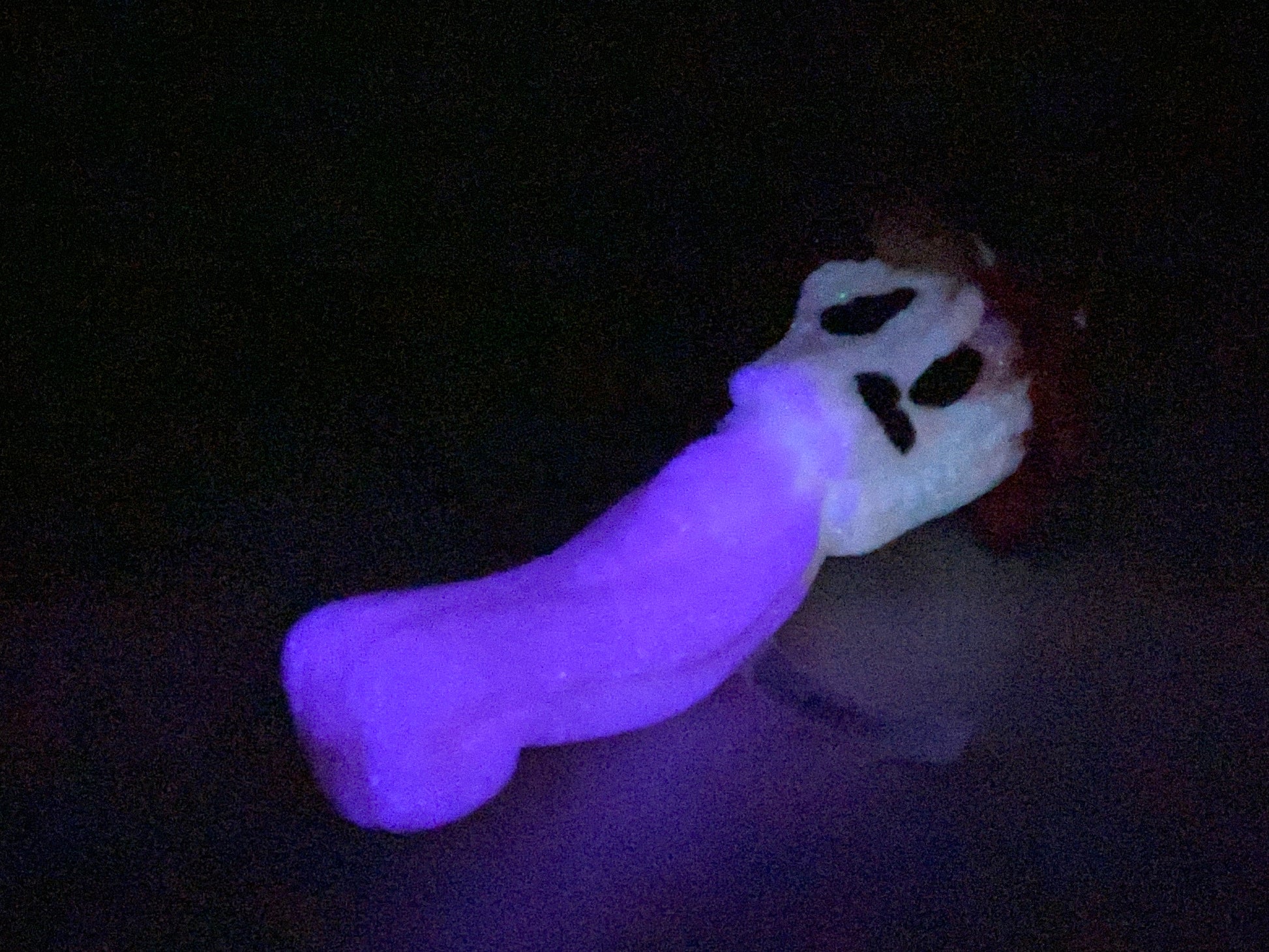 a glow in the dark toy with a ghost face on it