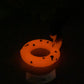 a lit up toilet seat in the dark