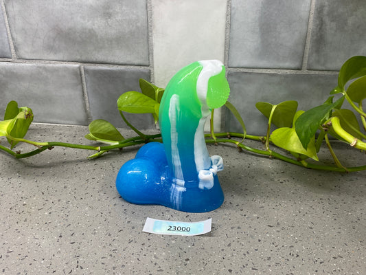 a green and white toothbrush sitting on top of a blue heart