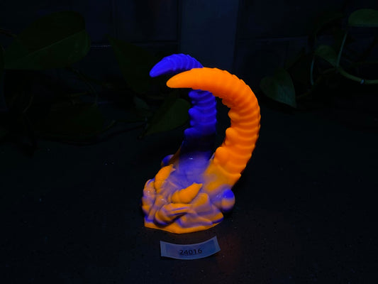 a yellow and blue sculpture sitting on top of a table