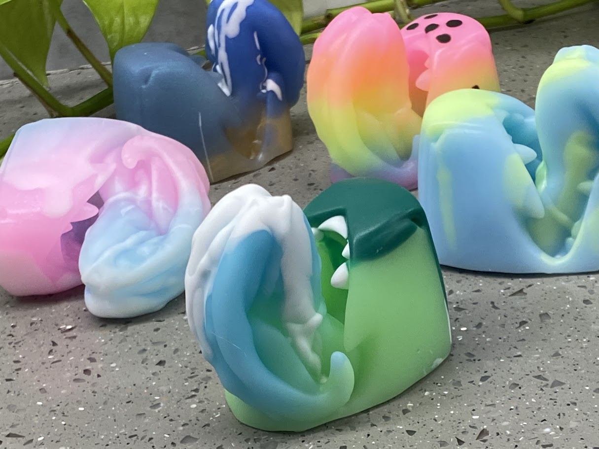 a group of soaps sitting on top of a cement ground