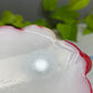 a red and white object sitting on top of a table