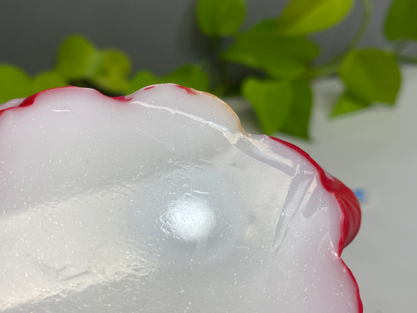 a red and white object sitting on top of a table