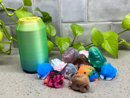 a group of small plastic animals sitting next to a can