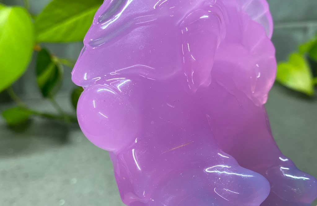 a close up of a purple bear statue