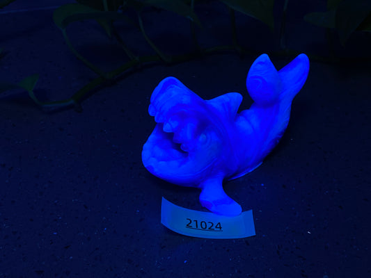 a blue figurine of a fish on a table