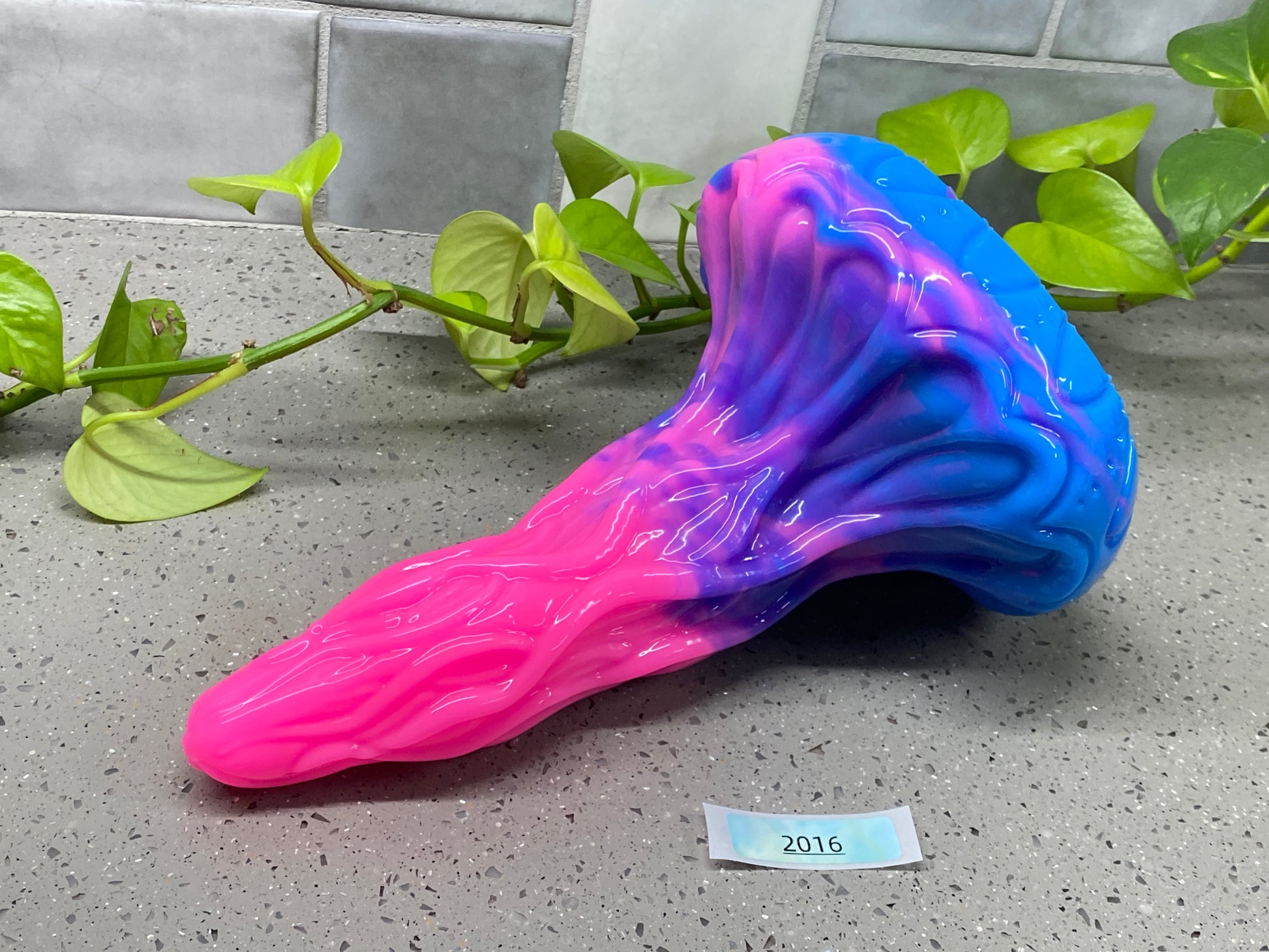 a purple and blue vase sitting on top of a counter