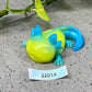 a yellow and blue lizard figurine sitting on top of a table