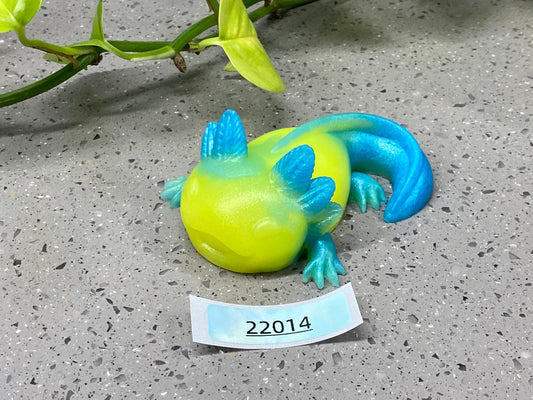a yellow and blue lizard figurine sitting on top of a table