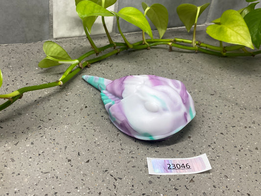 a purple and green shell sitting on top of a table