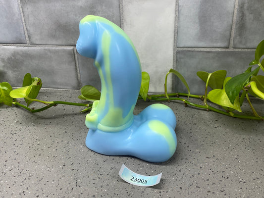 a blue and green vase sitting on top of a counter