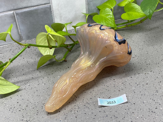 a vase sitting on top of a counter next to a plant