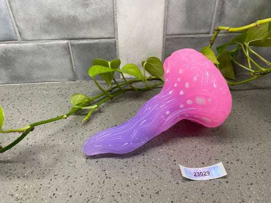 a pink and purple vase sitting on top of a counter