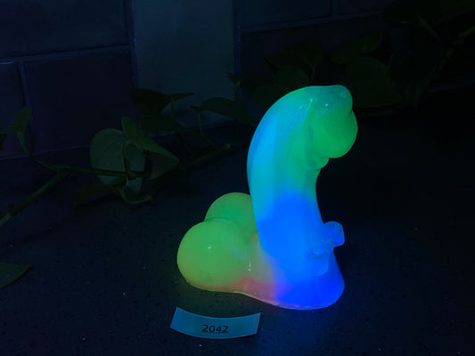 a glowing object sitting on a table next to a plant