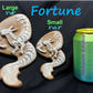 a cookie shaped like a dragon next to a can of fortune