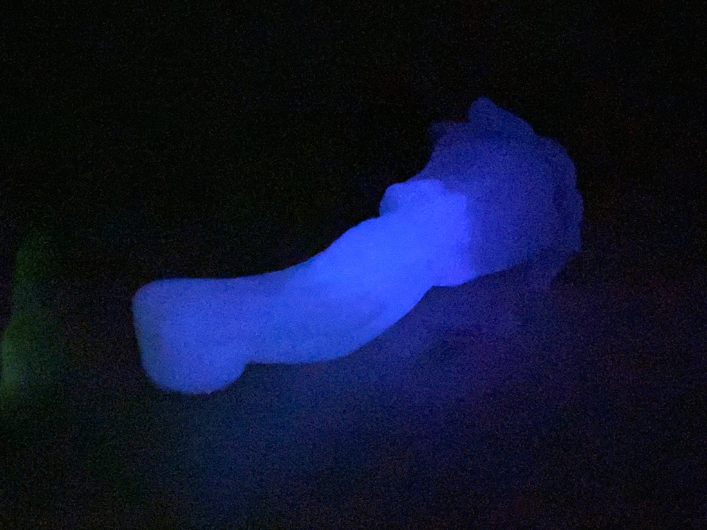 a person laying down in the dark with a glowing object