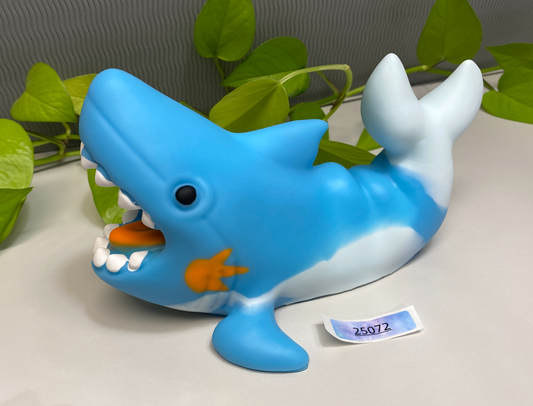 a blue and white dolphin toy with a name tag