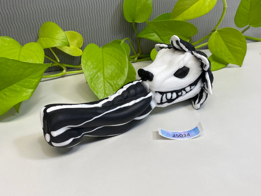 a fake toothbrush with a black and white striped mouth