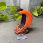 a fake snake is on a table next to a plant