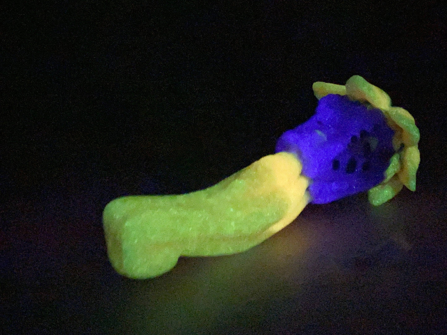 a purple and yellow toy laying on top of a table