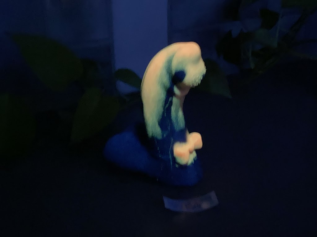 a blurry image of a person sitting on a stool