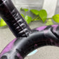 a close up of a purple and black bike handle