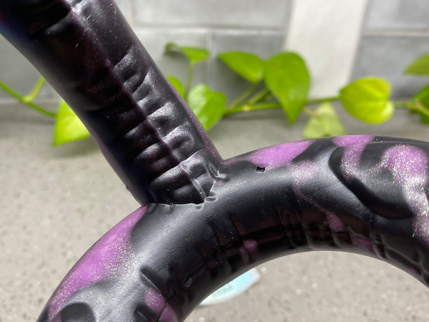 a close up of a purple and black bike handle
