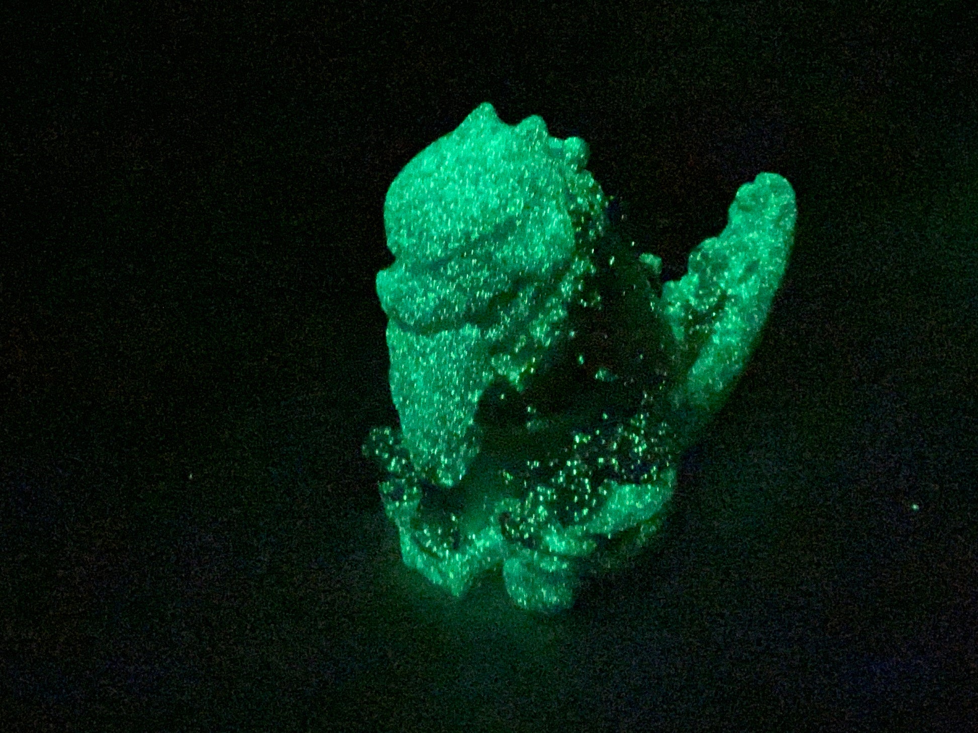 a green object is glowing in the dark