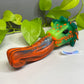 a green and orange toy laying on top of a table