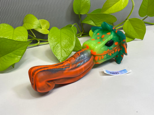 a green and orange toy laying on top of a table