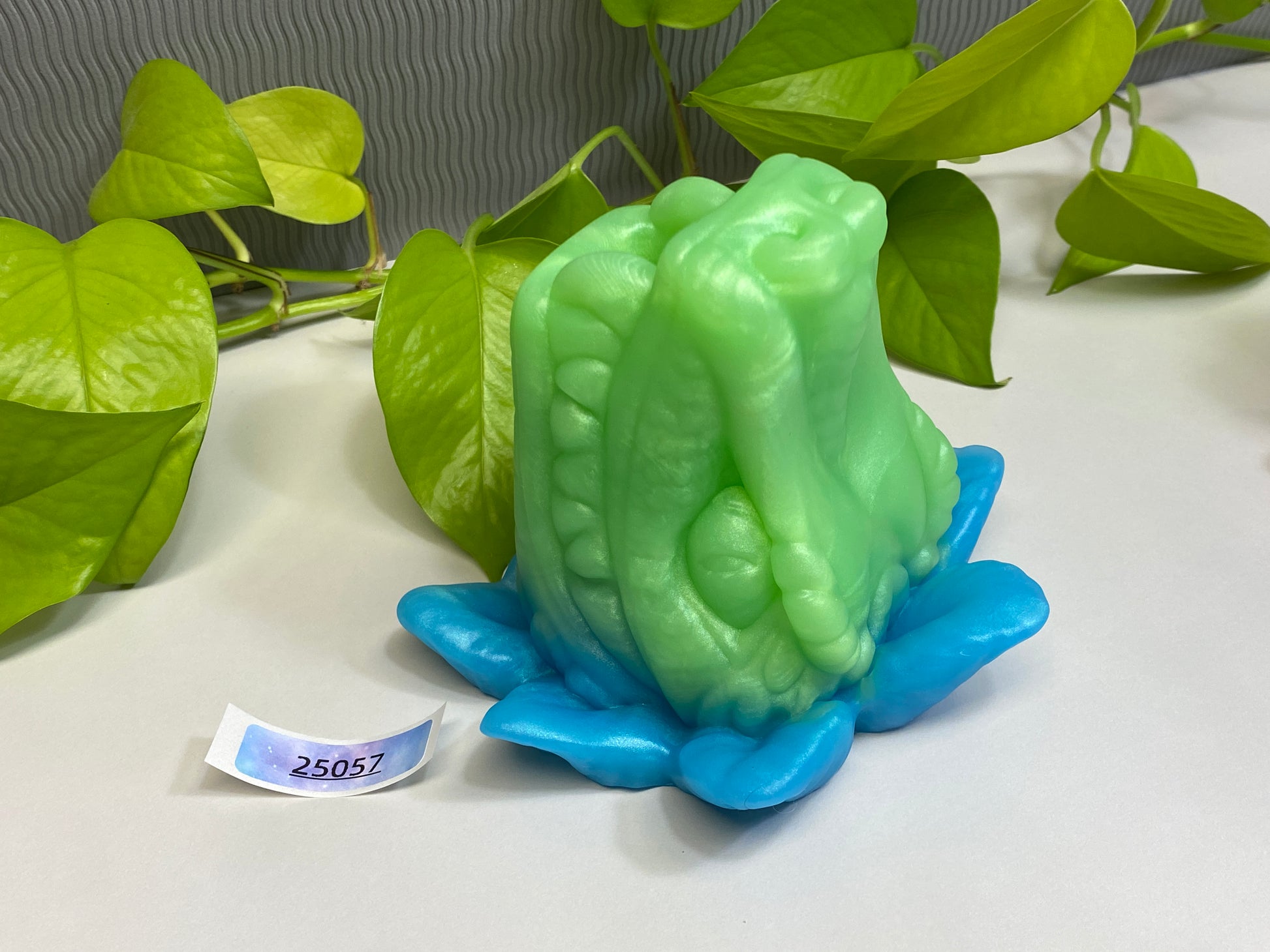 a green and blue sculpture sitting on top of a table