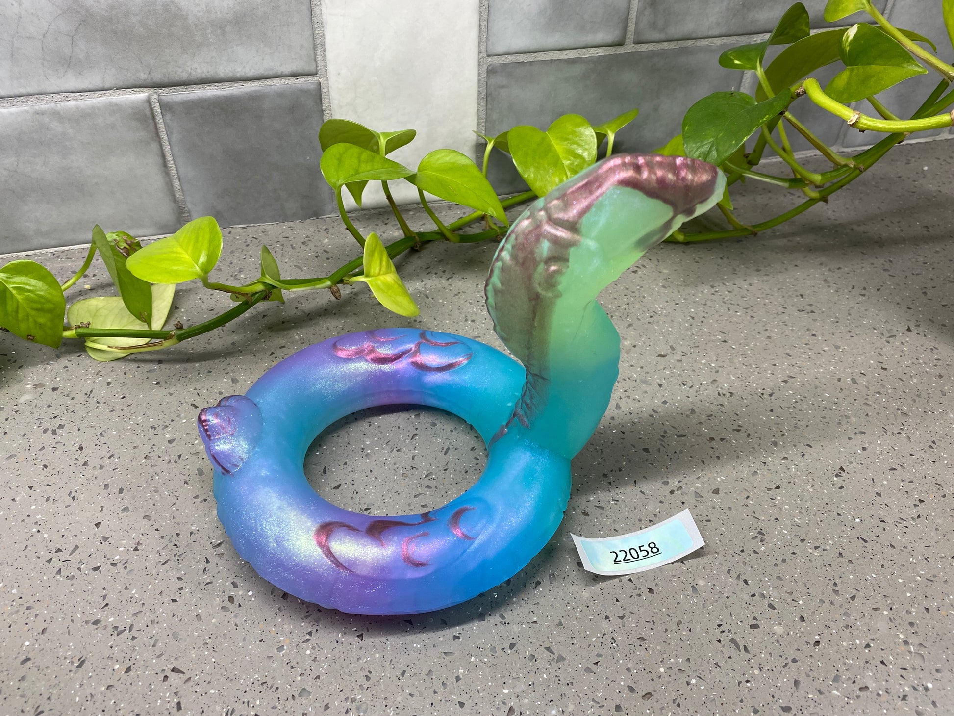 a blue and purple ring sitting on top of a counter