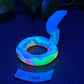 a glow in the dark snake shaped object on a table