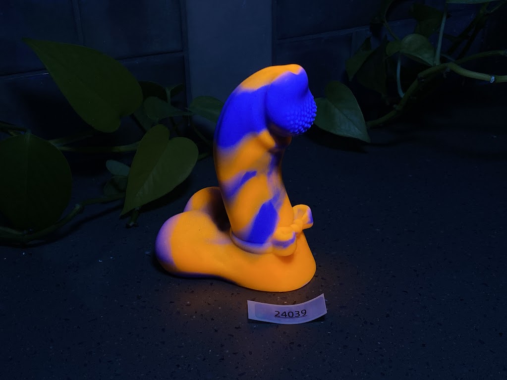 a yellow and blue figurine sitting on top of a table